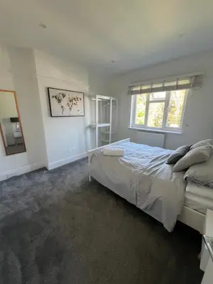 a bedroom with a large bed and a window at Salvation View 2 Bed Apartment in Hadleigh