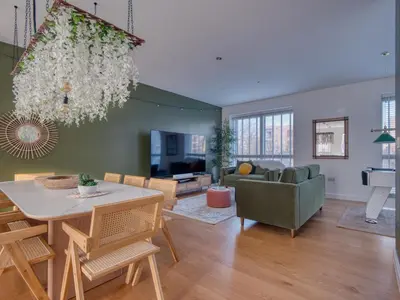 a living room with a table and a couch at Cambridge - hot tub, sauna, parking, pool table in Trumpington