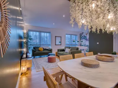 a living room with a table and a couch at Cambridge - hot tub, sauna, parking, pool table in Trumpington