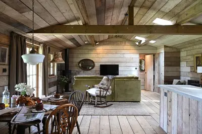 a living room with a couch and a table at The Farmstead in Euston