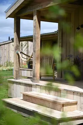 a building with a porch with steps in a yard at The Farmstead in Euston