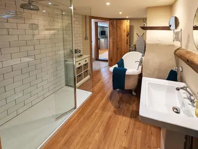 a bathroom with a sink and a shower at Chinnerys Country Cottage in Cavendish