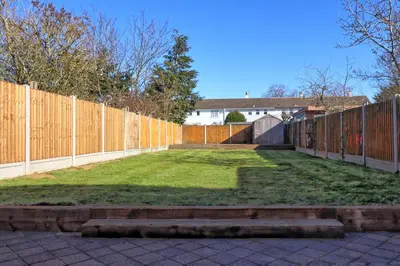 a backyard with a fence and a grass yard at 3 Bed, Sleeps 6, Wifi, Free Parking in Writtle
