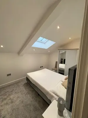 a bedroom with a bed and a skylight at Stunning 2-bed house in Great Warley, Brentwood in Great Warley Street