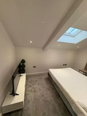 a bedroom with a large bed and a skylight at Stunning 2-bed house in Great Warley, Brentwood in Great Warley Street