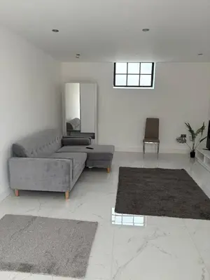 a living room with a couch and two rugs at Stunning 2-bed house in Great Warley, Brentwood in Great Warley Street