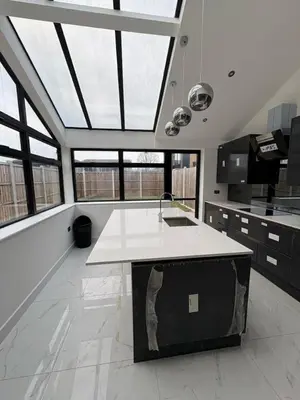 a kitchen with a island in the middle of a room with windows at Stunning 2-bed house in Great Warley, Brentwood in Great Warley Street