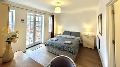 a bedroom with a bed and two lamps and a table at Ipswich Inn in Ipswich