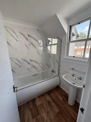a bathroom with a shower and a sink at Ipswich Inn in Ipswich