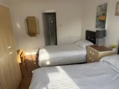 a hotel room with two beds and a tv at Ipswich Inn in Ipswich