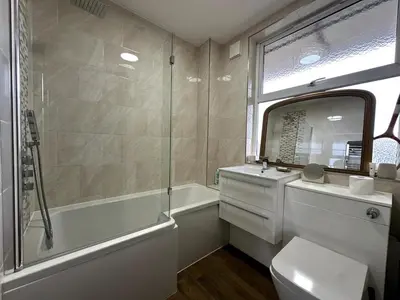 a bathroom with a tub and a sink and a toilet at Flat-on-Sea in Southend-on-Sea
