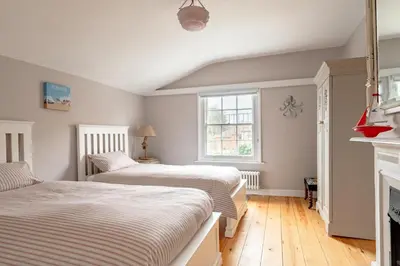 two beds in a room with a fireplace at 4 Bed in Aldeburgh oc-e28371 in Aldeburgh