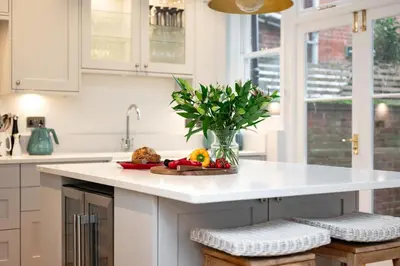 a kitchen with a vase of flowers on a counter at 4 Bed in Aldeburgh oc-e28371 in Aldeburgh