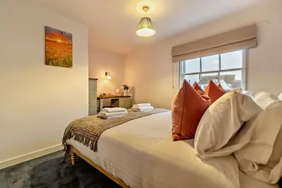 a bedroom with a large bed with a window at 2 Bed in Lavenham oc-t30056 in Lavenham