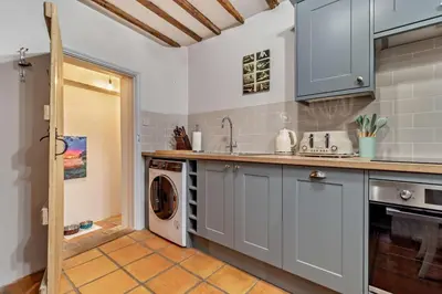 a kitchen with a washer and a washing machine at 2 Bed in Lavenham oc-t30056 in Lavenham