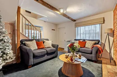 a living room with two couches and a christmas tree at 2 Bed in Lavenham oc-t30056 in Lavenham
