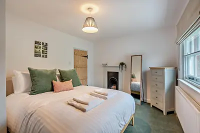 a bedroom with a bed with towels on it at 2 Bed in Lavenham oc-f30054 in Lavenham