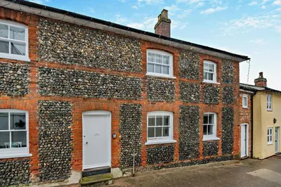 a brick building with a wall covered in plants at 2 Bed in Lavenham oc-f30054 in Lavenham