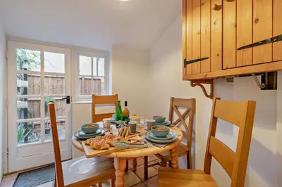 a dining room with a wooden table and chairs at 2 Bed in Lavenham oc-s30055 in Lavenham