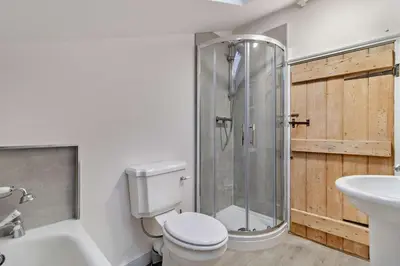 a bathroom with a shower and a toilet and a sink at 2 Bed in Lavenham oc-s30055 in Lavenham