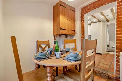 a dining room with a wooden table and chairs at 2 Bed in Lavenham oc-s30055 in Lavenham