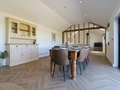 a kitchen with a dining room table and chairs at The Hide in Colchester