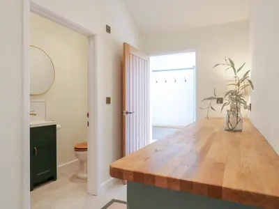 a kitchen with a wooden counter top in a bathroom at The Hide in Colchester