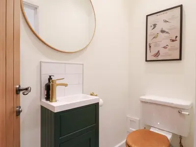 a bathroom with a sink and a mirror at The Hide in Colchester