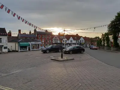 a town with cars parked in a parking lot at The Crown Hotel in Framlingham