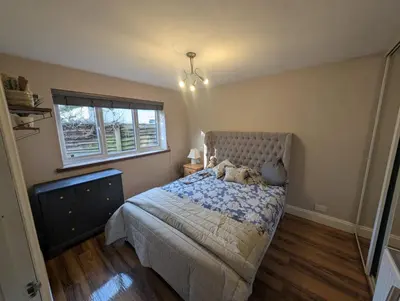 a bedroom with a bed and a window at Barn conversion Corner Annexe in Earls Colne