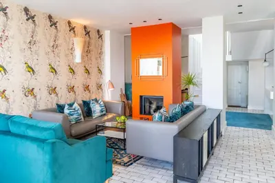 a living room with two couches and a fireplace at Edinburgh House in Aldeburgh