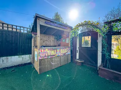 a wooden out house with graffiti on it with a door at Basildon Retreat Cozy 3-Bedroom Home in Basildon