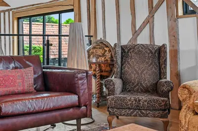 a living room with a couch and a chair at The Hare's Field, Wethersfield in Wethersfield