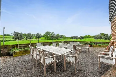 a table and chairs sitting on a gravel patio at The Hare's Field, Wethersfield in Wethersfield
