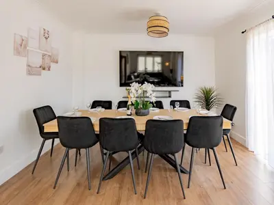 a dining room with a table and chairs at Hawkwell Retreat 5 Bedroom home Hockley - Pass the Keys in Hawkwell