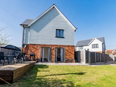 a detached house with a garden and a patio at Hawkwell Retreat 5 Bedroom home Hockley - Pass the Keys in Hawkwell