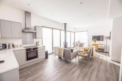 a kitchen and living room with a table and chairs at The Haywain, Flatford in East Bergholt
