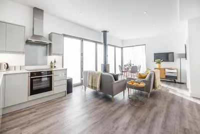 a kitchen and a living room with a table at The Haywain, Flatford in East Bergholt
