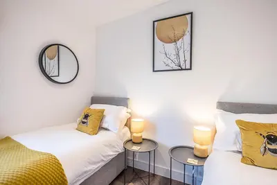 two twin beds in a room with two lamps at The Haywain, Flatford in East Bergholt