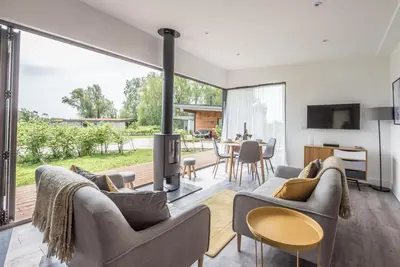 a living room with a couch and a fireplace at The Haywain, Flatford in East Bergholt