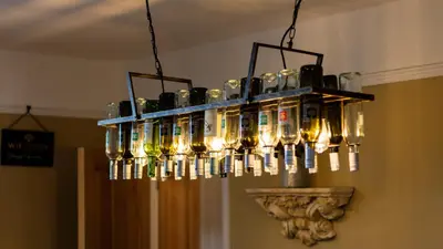 a chandelier with bottles of wine hanging from a ceiling at Paradise Penthouse in Downham Market