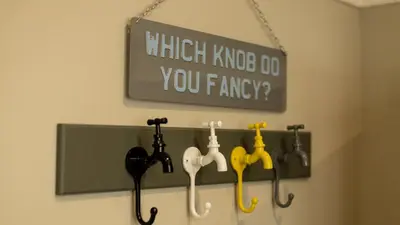 a sign hanging on a wall with different types of umbrellas at Paradise Penthouse in Downham Market