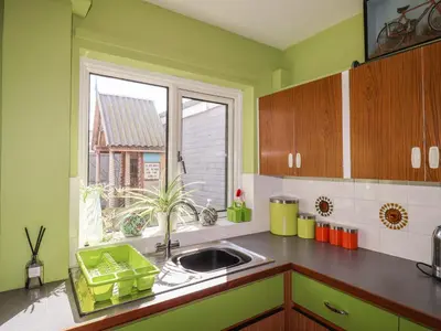a kitchen with a sink and a window at The Orchard Close Art House in Great Livermere
