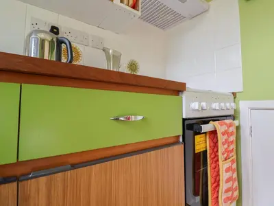 a kitchen with a green counter top and an oven at The Orchard Close Art House in Great Livermere