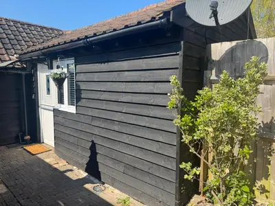 a side view of a house with a satellite at Chandini Villa in High Wych in Sawbridgeworth