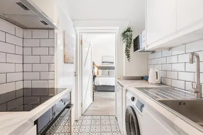 a kitchen with a sink and a dishwasher at Chandini Villa in High Wych in Sawbridgeworth