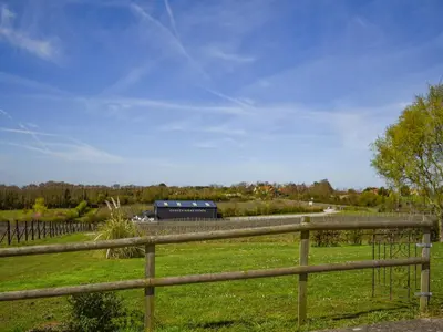 a wooden fence in a field with a barn at Thistle No4 - Uk49250 in Althorne