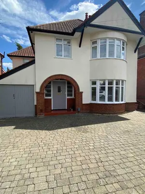 a large white house with a brick driveway at 4 Bedroom Detached House Sleeps 7 in Ipswich