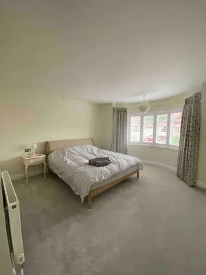 a bedroom with a bed and a window at 4 Bedroom Detached House Sleeps 7 in Ipswich