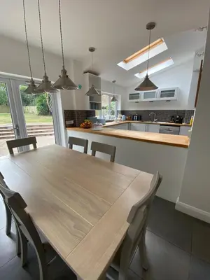 a kitchen with a wooden table and chairs at 4 Bedroom Detached House Sleeps 7 in Ipswich